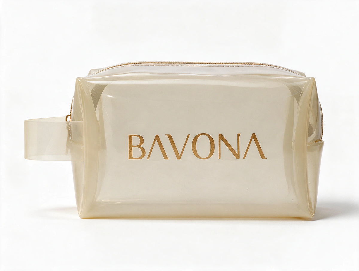 The Bavona Ritual Pouch, translucent pearl-ivory pouch with a gold-toned zip and the Bavona name in gold, front view on a white background